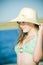 Teen girl at lake with sunhat