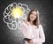 Teen girl, large brain and light bulb, chalkboard