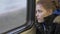 Teen Girl Leans Against Train Window