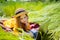 Teen girl learns working on laptop lying on meadow. mobile Internet in rural