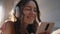 Teen girl listening music in headphones closeup. Happy female typing message