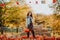 Teen girl with long hair posing with pumpkins at the open farm market place. Autumn background