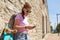 Teen girl with longboard, smartphone and earphones