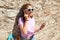 Teen girl with longboard, smartphone and earphones