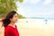 Teen girl looking at ocean on empty Hawaiian beach