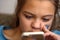 Teen girl looks at the phone. Face close up