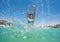 Teen girl making splashes in clear sea water