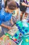 Teen girl participating at water color painting on dough figures