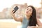 Teen girl photographing a selfie with a smart phone