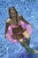 Teen girl in pink bikini on a float