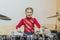 Teen girl playing the drums. Teen girls are having fun playing drum sets in music class