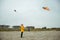 Teen girl playing with kites in sand dunes of Baltic coastline