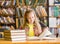 Teen girl reading a book in the library