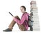 Teen girl reads ebook near the stack of books