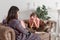 Teen girl on reception at the psychotherapist. Psychotherapy session for children. The psychologist works with the patient. Girl