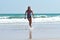 Teen girl running on the beach. Happy child on the sea
