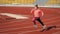teen girl running on outdoor stadium racing track, marathon