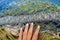 Teen girl`s hand touching colourful fishing nets