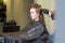 Teen Girl In Salon Drying her Hair with Blow Dryer