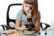 Teen girl in school laboratory. Researcher working with microscope