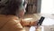 Teen girl school student wear headphones hold mobile phone learning online with teacher.