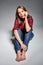 Teen girl sitting barefooted at floor looking at camera