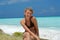 Teen girl sitting on beach