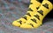 Teen girl sitting on couch. Yellow socks with black Batman pattern. Side view