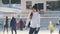 Teen girl skating on outdoor public ice rink