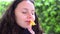 Teen girl smelling yellow flower