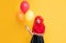 teen girl smile with party balloon on yellow background