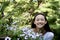 A Teen Girl Smiles in a Flower Garden