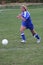 Teen Girl Soccer Player Chasing Ball