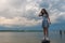 Teen girl standing on bollard in front of Potomac River