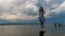 Teen girl standing on bollard in front of Potomac River