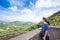 Teen girl standing looking out over view of eastern Oahu