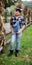 Teen girl standing next to cornstalks on a farm in Ohio 