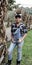 Teen girl standing next to cornstalks on a farm in Ohio 