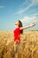 Teen girl staying at a wheat field