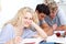 Teen girl studying in the library with her friends