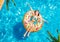 Teen girl swim in pool on inflatable yellow ring