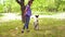 Teen girl trains a dog giving her a command to stand on its hind legs and the dog executes commands. Work on exercise