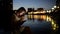 Teen girl using a tablet PC on the riverside