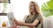 Teen girl video chatting using digital tablet on sofa