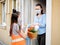 Teen girl volunteer delivers food to the house during the quarantine.