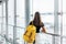 Teen girl waiting for international flight in airport departure terminal