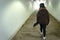 Teen Girl walking through a tunnel with her skateboard