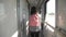 Teen girl walks on a train compartment car with a backpack. Travel transportation railroad concept.Little girl walking