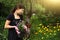 Teen girl work on landscaping garden design hold pot with pansies