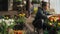 Teen girl working in the greenhouse with blooming tulips